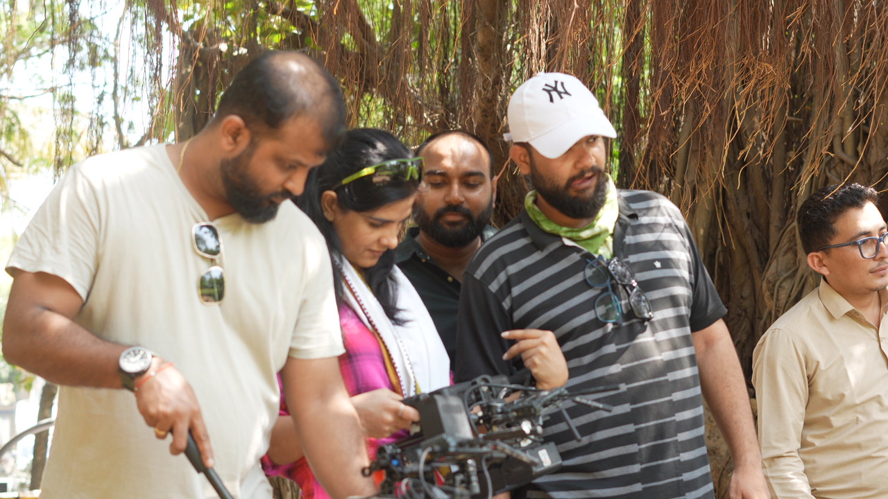 Production crew reviewing camera equipment on location