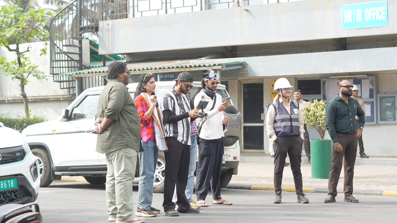 Drone operator and crew coordinating on a commercial set